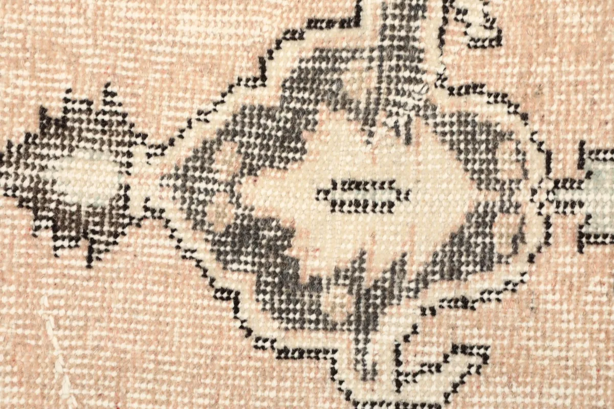 Detailed view of the low wool pile and hand-knotted texture of the rug