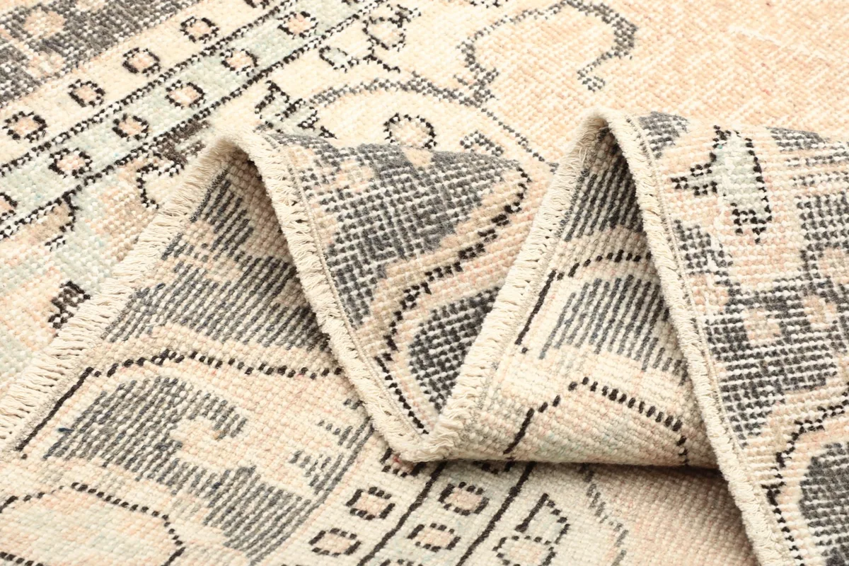 Folded section of the rug showing the overall pattern and texture