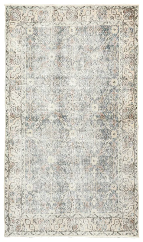 Full top view of the 4x7 muted blue floral vintage Anatolian area rug