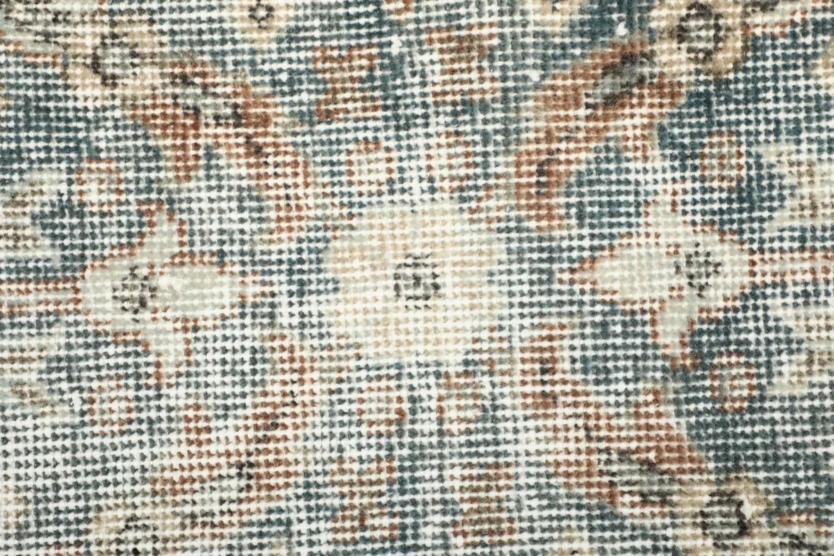Close-up detail of the low wool pile and hand-knotted texture of the rug