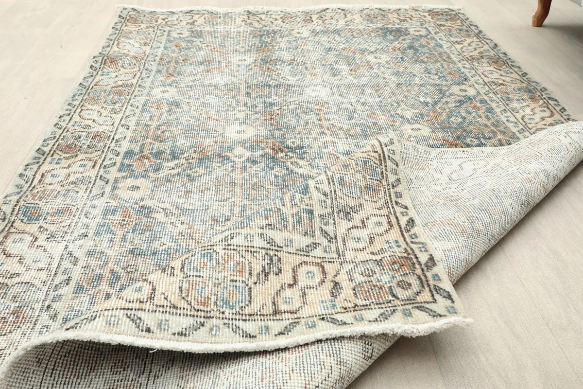 View of the rug folded back, showcasing both the pile and the foundation