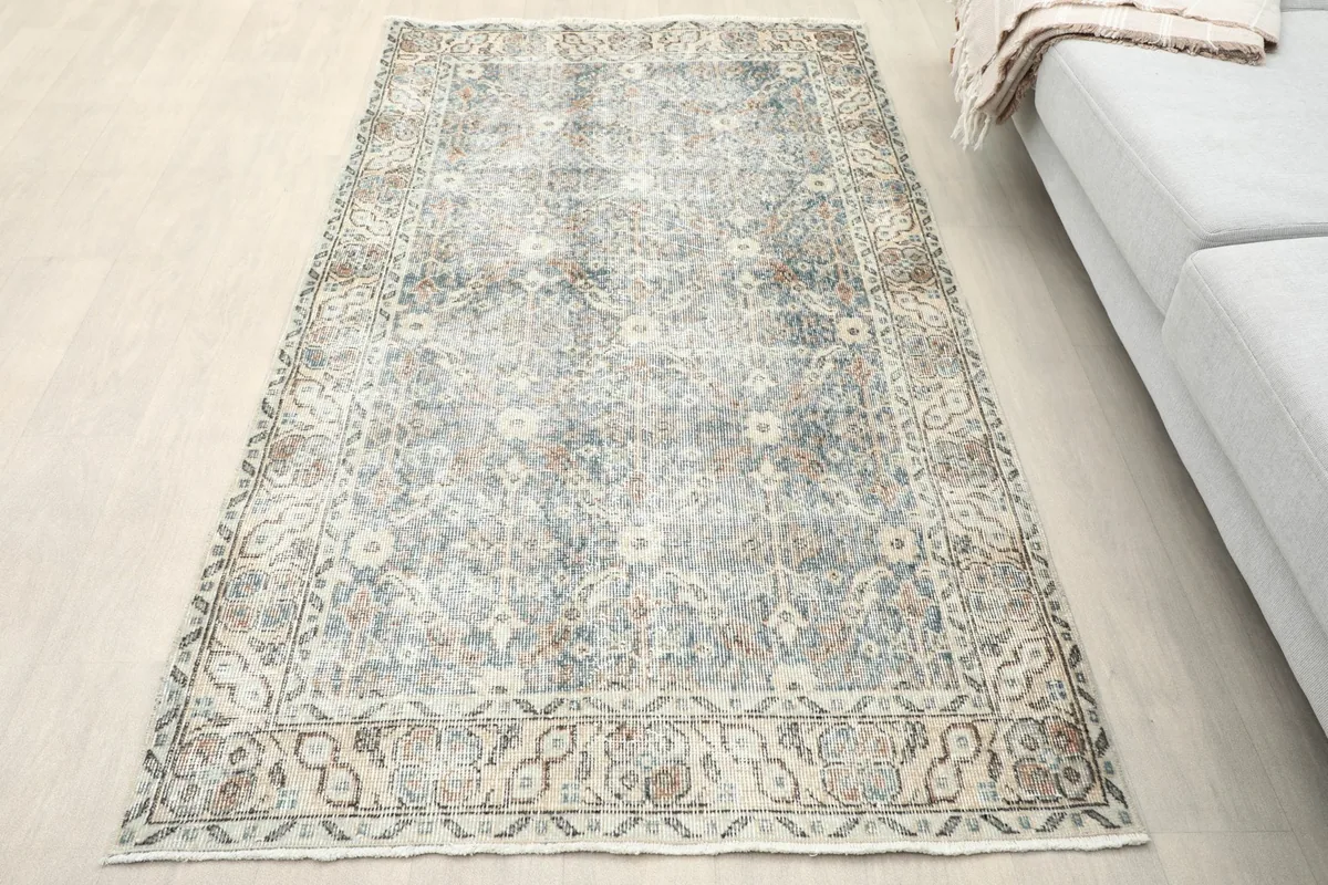 Overhead view of the blue and beige vintage rug in a room setting