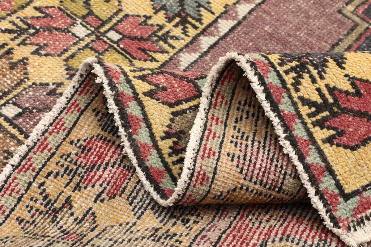 Folded section of the rug, showing the flexibility and density of the hand-knotted wool.