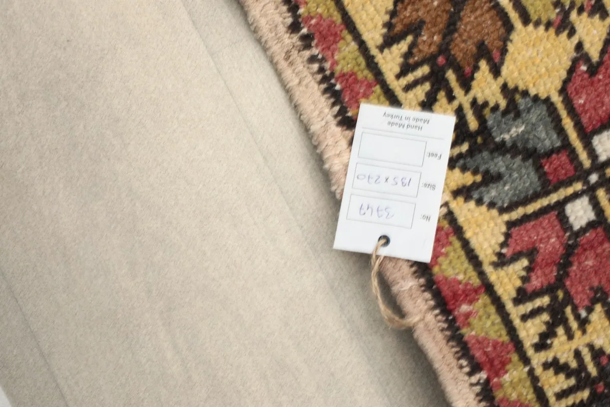 Rug tag displaying size information, resting on the folded rug.