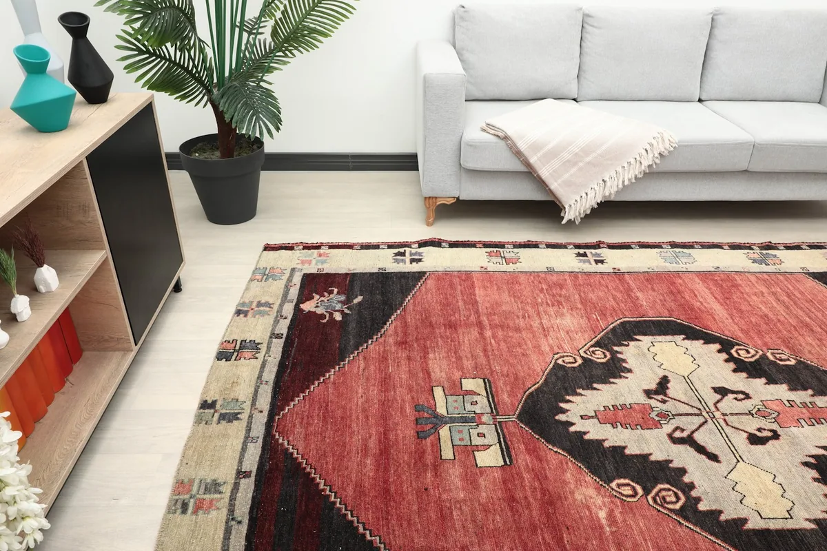 Partial view of the rug in a room, focusing on the central design and surrounding decor