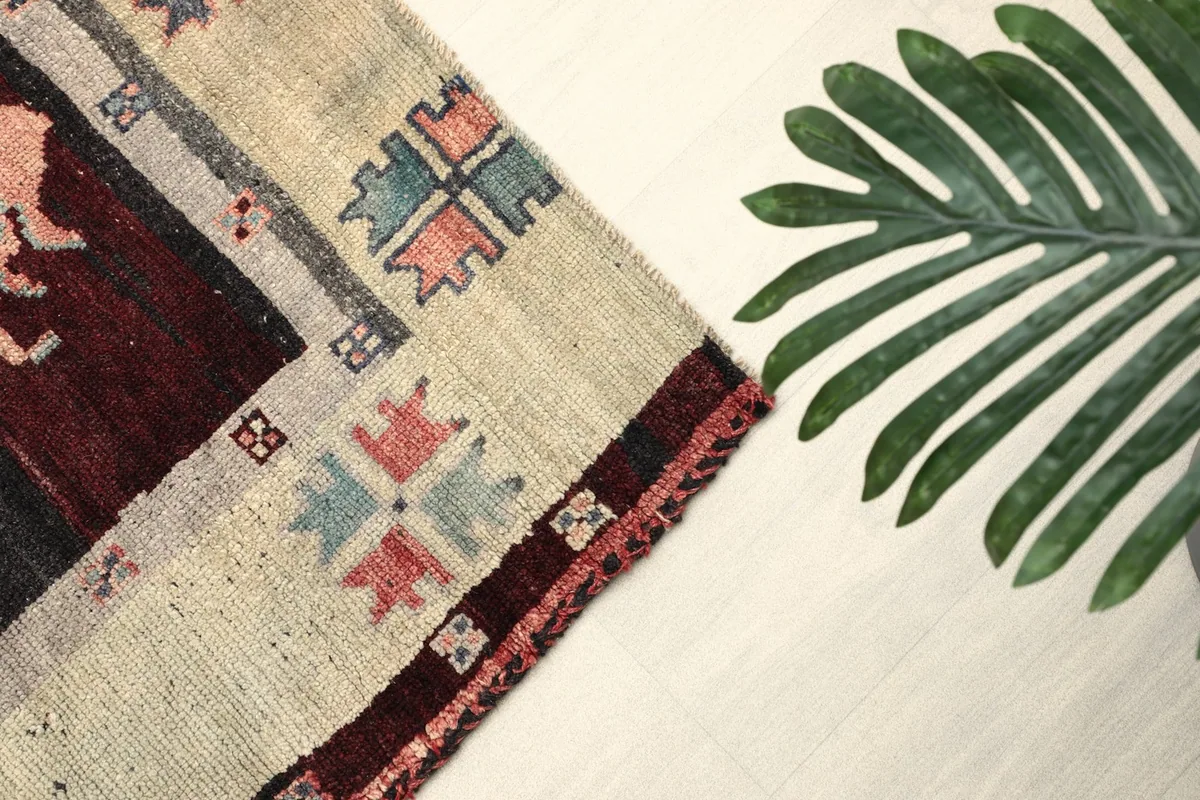 Close-up of the rug's border with geometric patterns in various colors