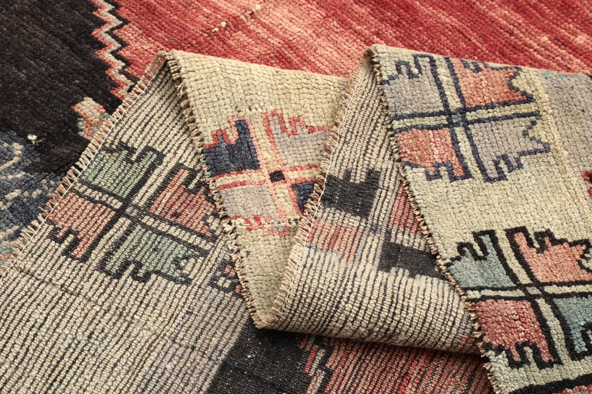 Multiple folds of the rug, showcasing the texture and varied colors of the pile