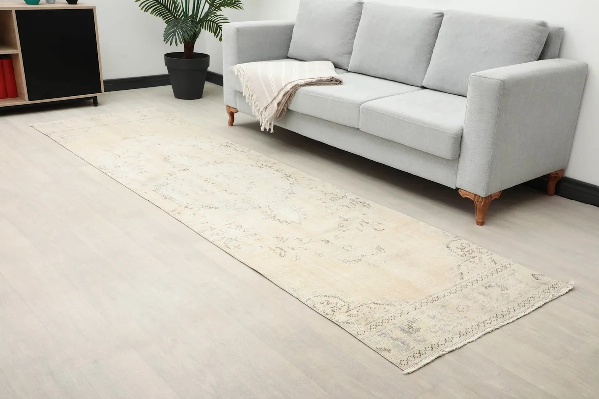 Overhead view of the runner rug in a room, showing its length next to a sofa.