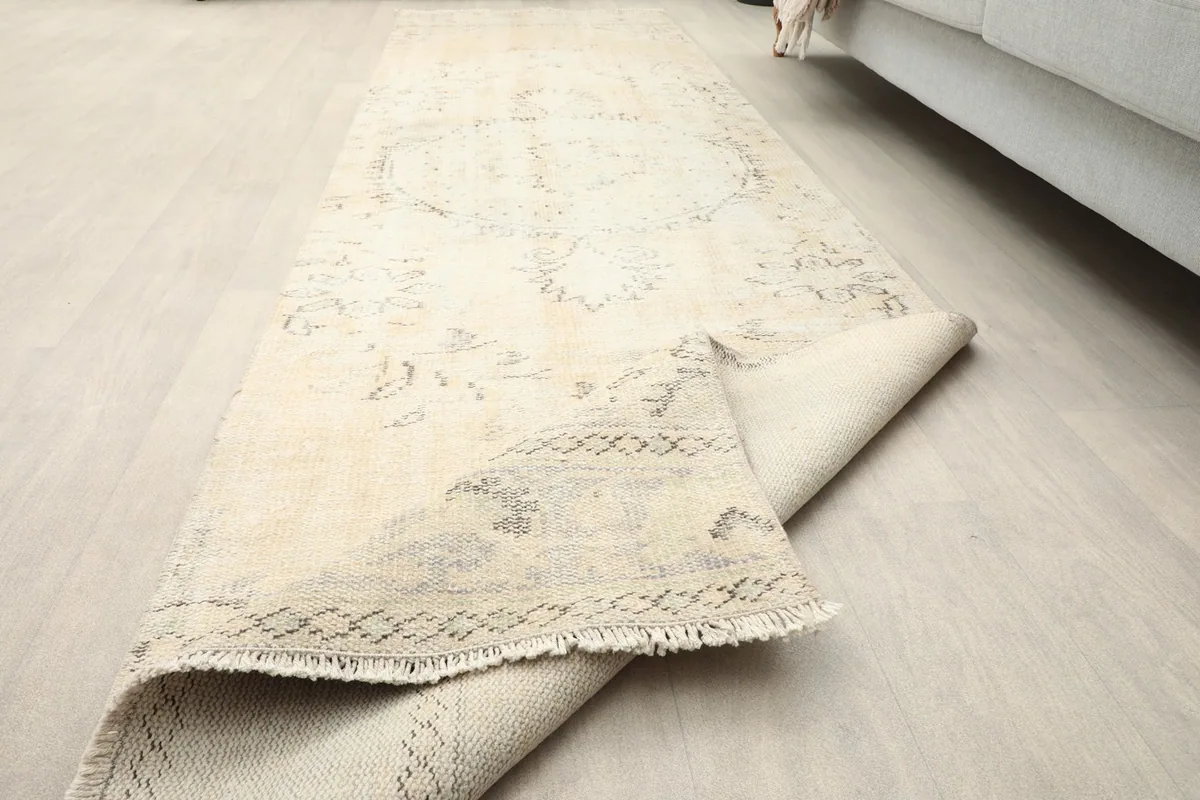 The runner rug partially folded, illustrating its flexibility and construction.