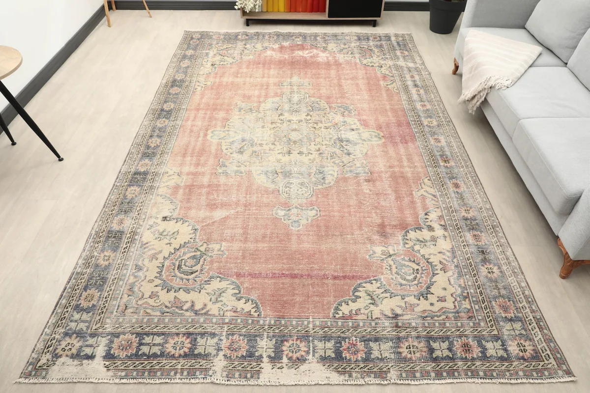 Vintage area rug in a living room setting, showing its size relative to a sofa