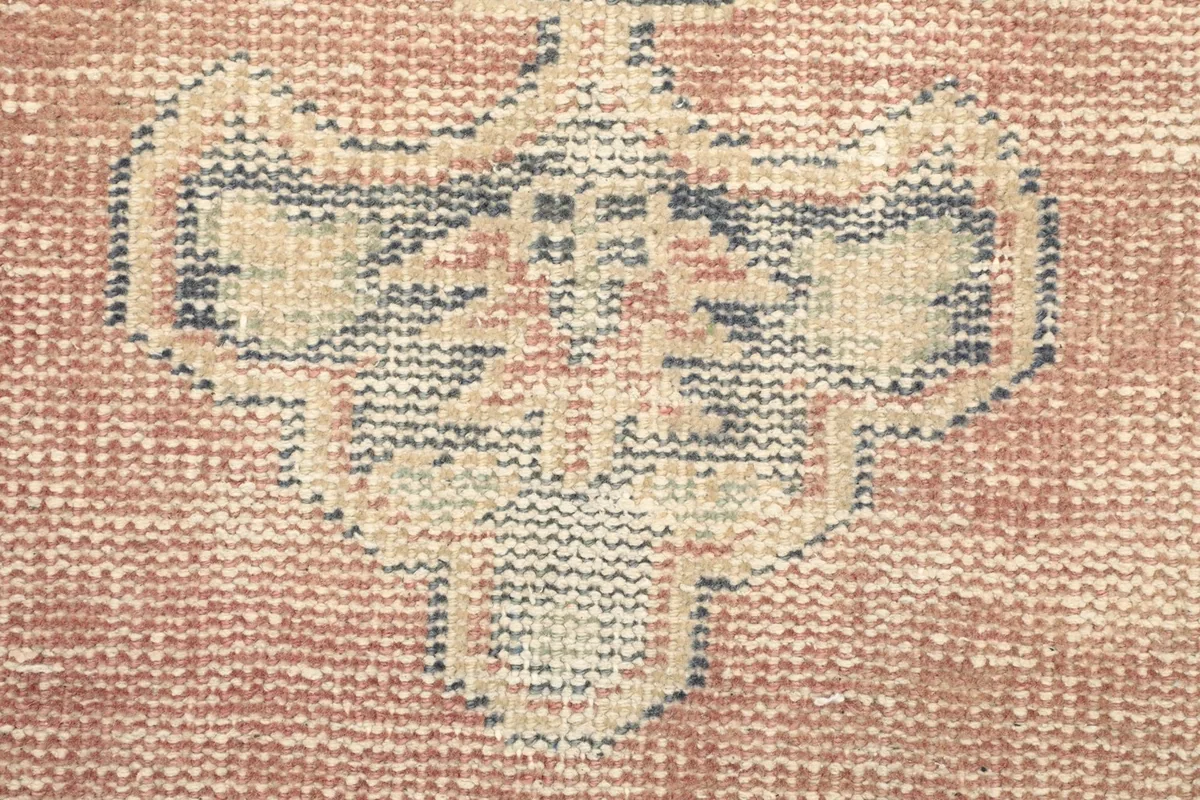 Texture and close-up of the hand-knotted wool pile, showing vintage wear and colors