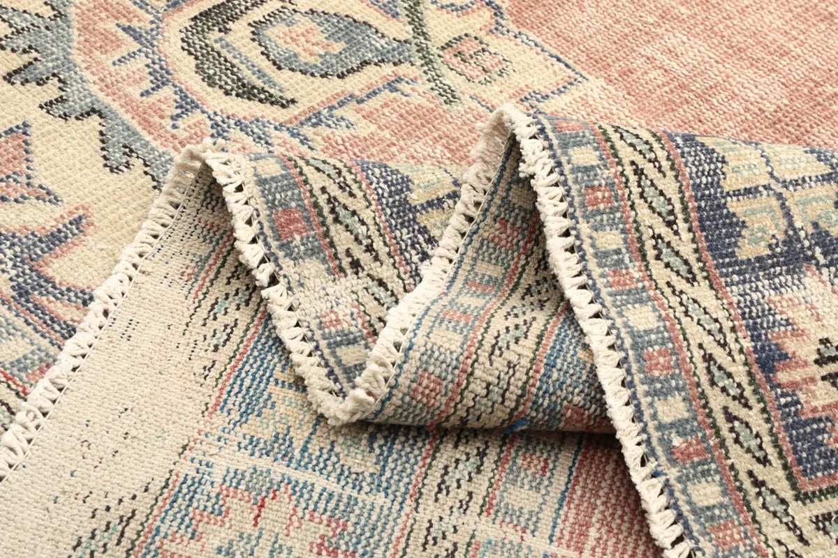 Detailed view of the rug's edge and border patterns when folded