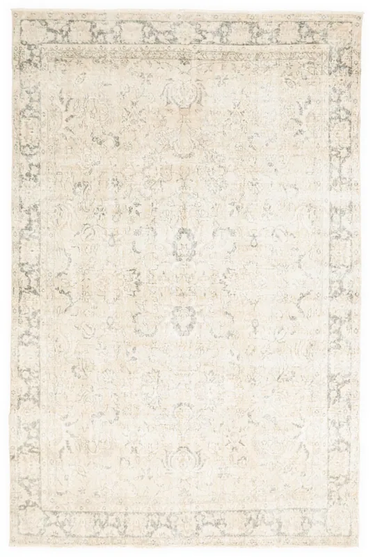 Full overhead view of the ivory and charcoal vintage Anatolian area rug on a white background