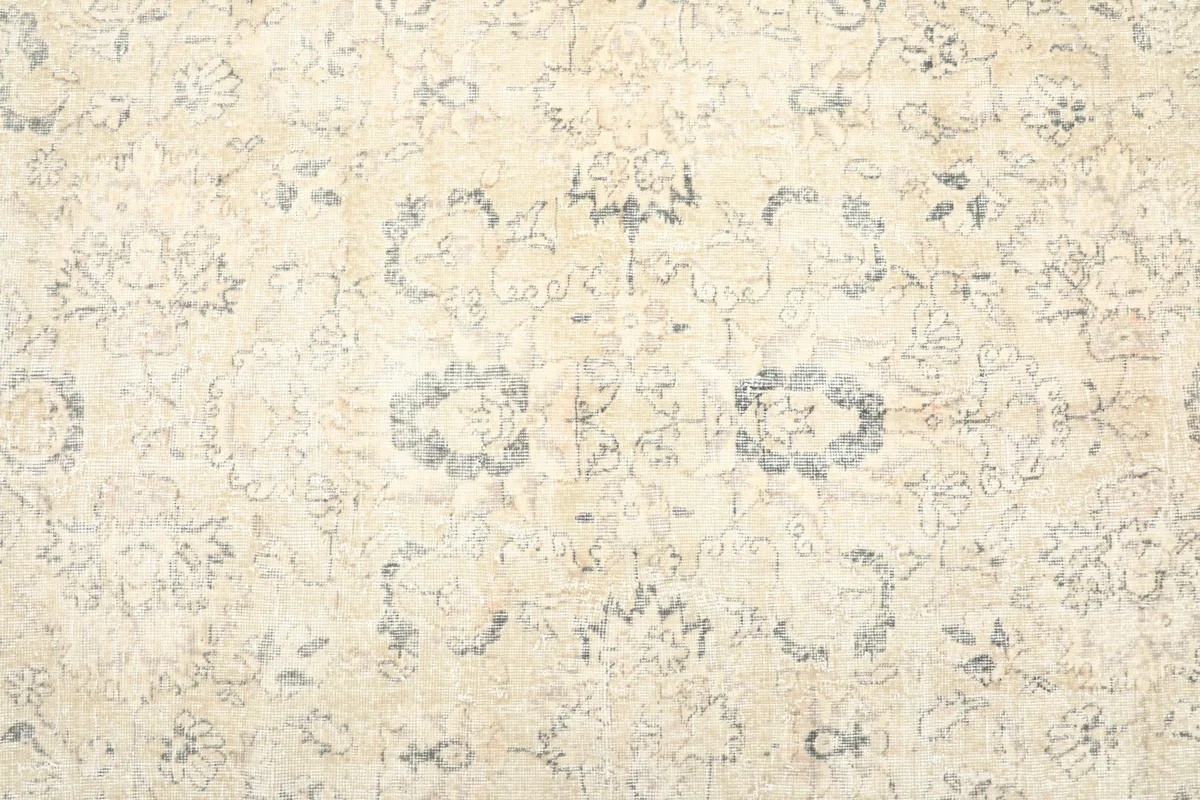Close-up of the central area, revealing faded floral and geometric patterns in ivory and charcoal