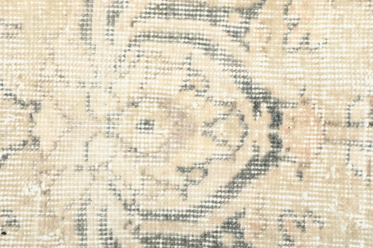 Detailed view of the low wool pile, showing the hand-knotted texture and distressed appearance