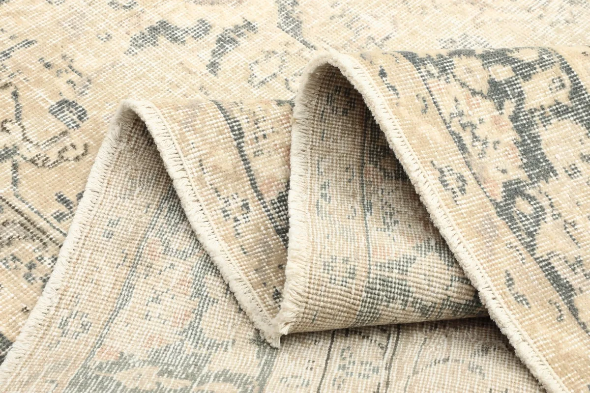 Multiple folds of the rug, revealing the soft wool pile and cotton foundation