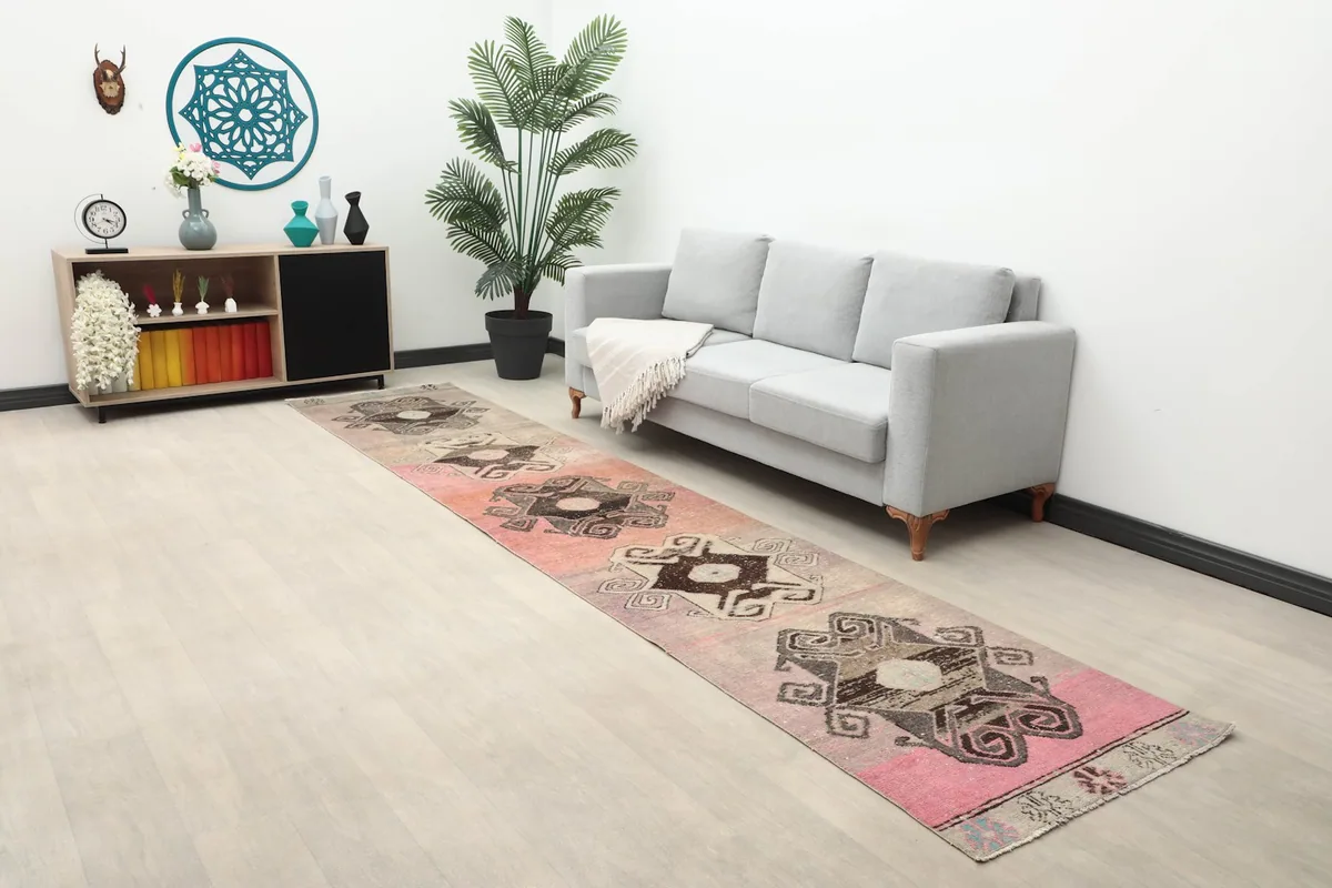 Long view of the Anatolian runner rug extending through a living space with a sofa