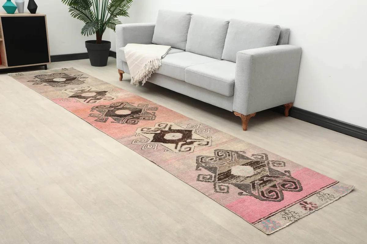 Angled view of the runner rug in a room, highlighting its geometric patterns and color variations