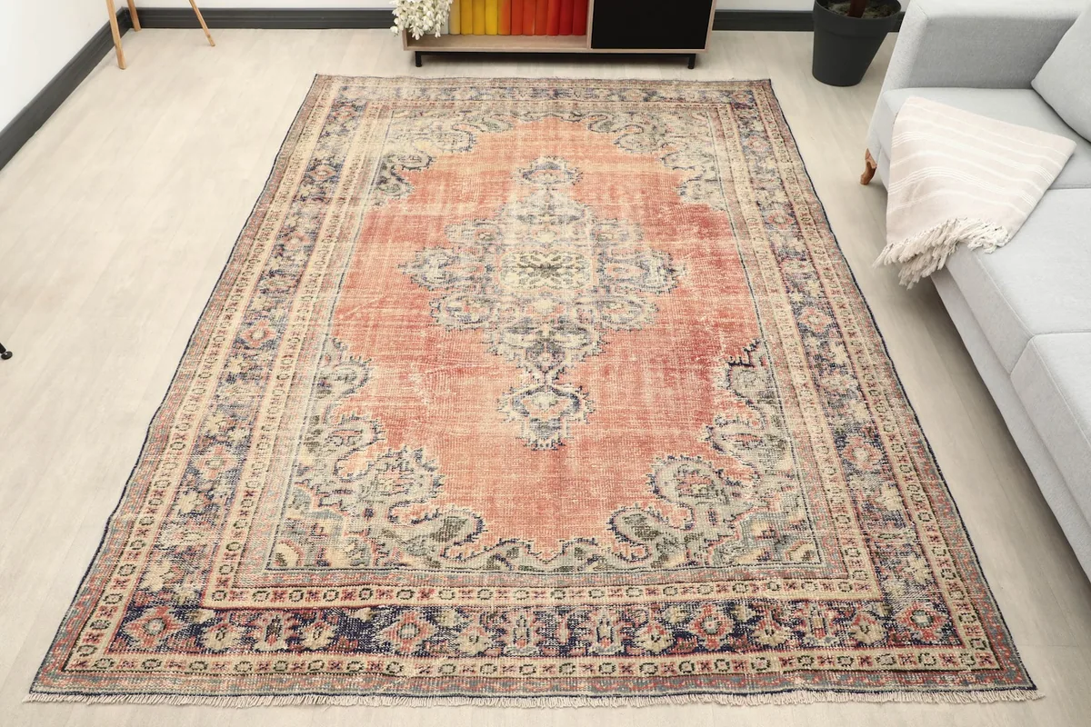 Vintage rust area rug in a modern living room setting from an overhead angle