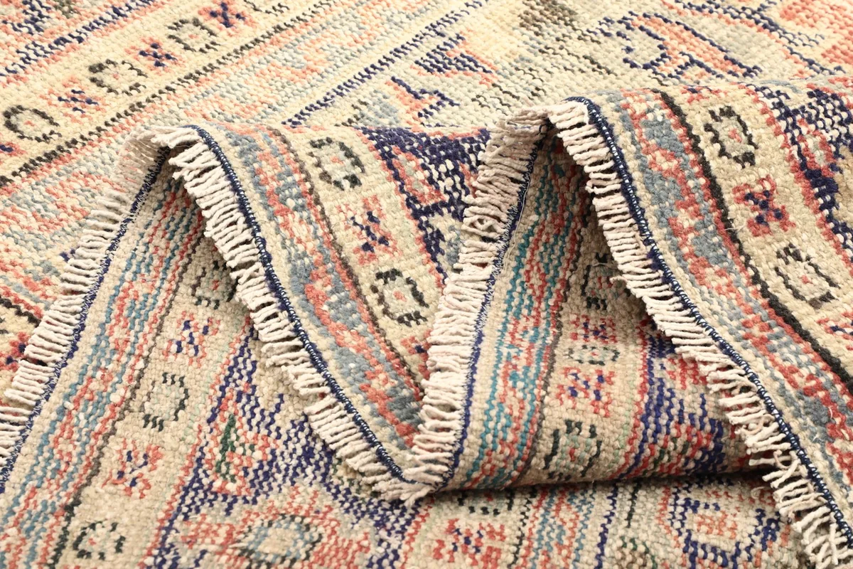 Close-up of the rug's fold, showing the wool pile and cotton foundation
