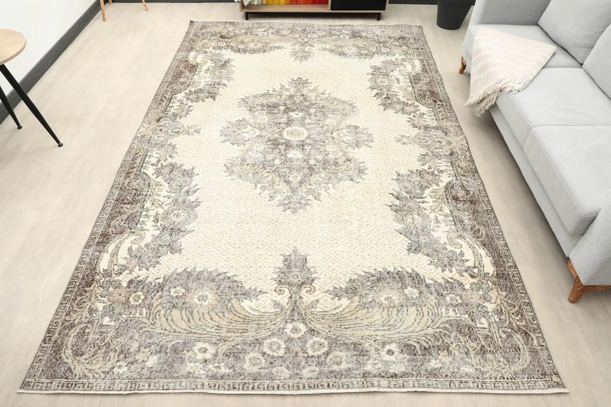 Vintage Anatolian rug in a living room setting with a light gray sofa