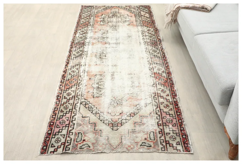 Full overhead view of the vintage Anatolian runner with cream and rust geometric patterns