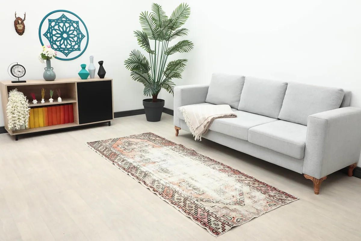 Vintage runner placed in a living room setting next to a gray sofa