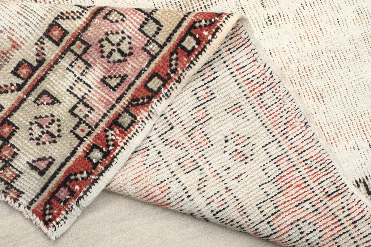 View of the rug's back, revealing the tight knotting and cotton foundation