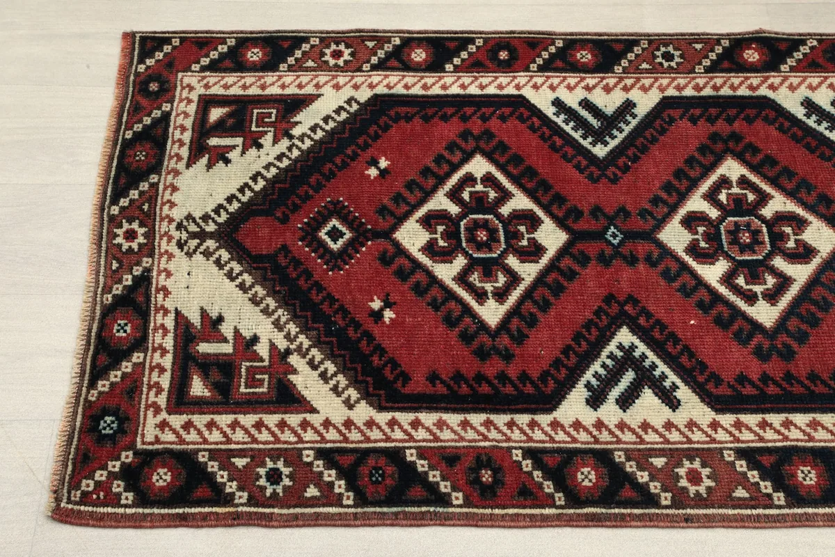 Detailed view of the rug's pattern and border, showing subtle color variations