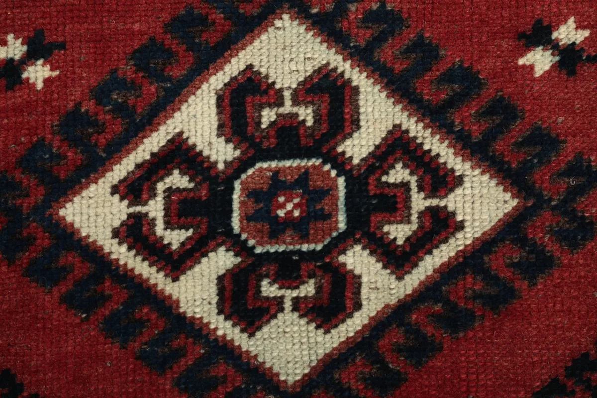Extreme close-up of the wool pile, showing the hand-knotted texture and color depth