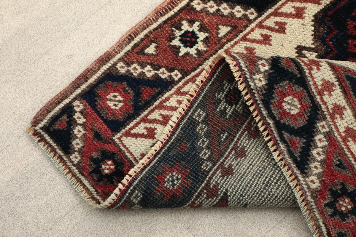 Close-up of the rug's back, showing the knotting structure and finish