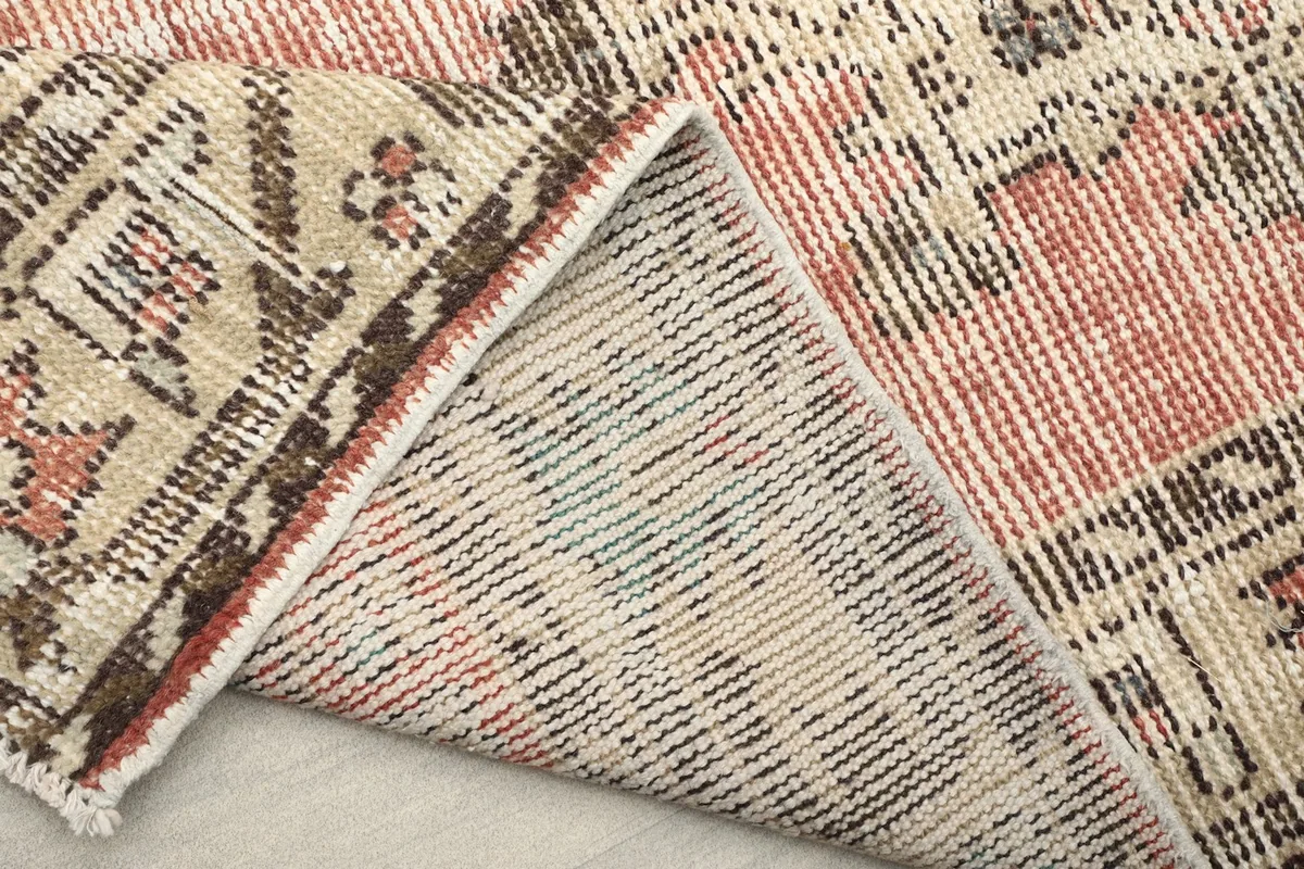 View of the back of the rug, showing the intricate hand-knotting and foundation
