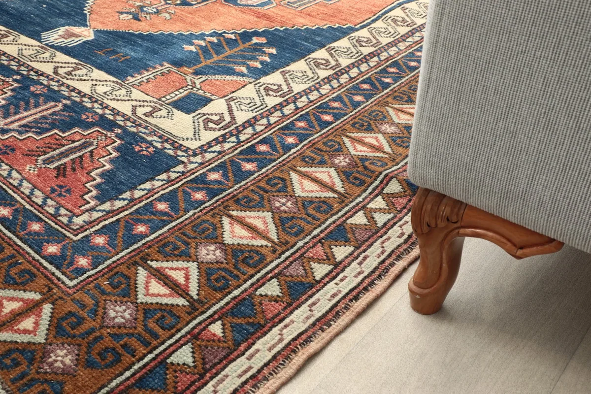Rug corner next to a sofa leg, showing its integration into home decor