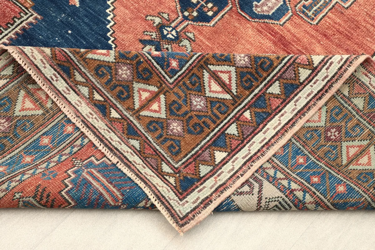 Folded corner of the rug showing the reverse side of the border