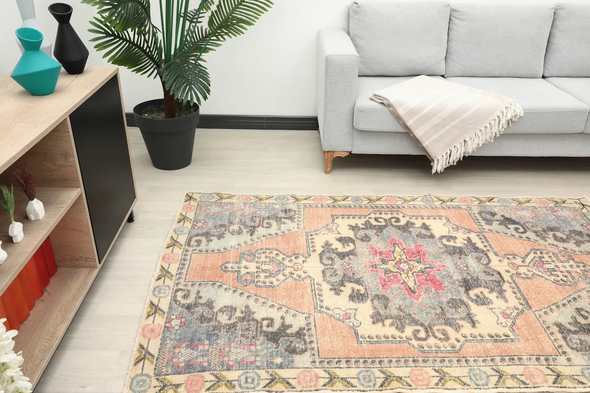 Overhead view of the rug in a room, showing its placement in front of a light gray sofa