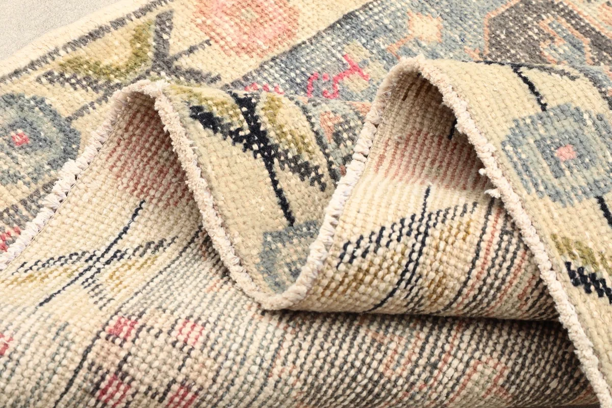 Folded rug showing the texture of the low wool pile and the intricate knotting
