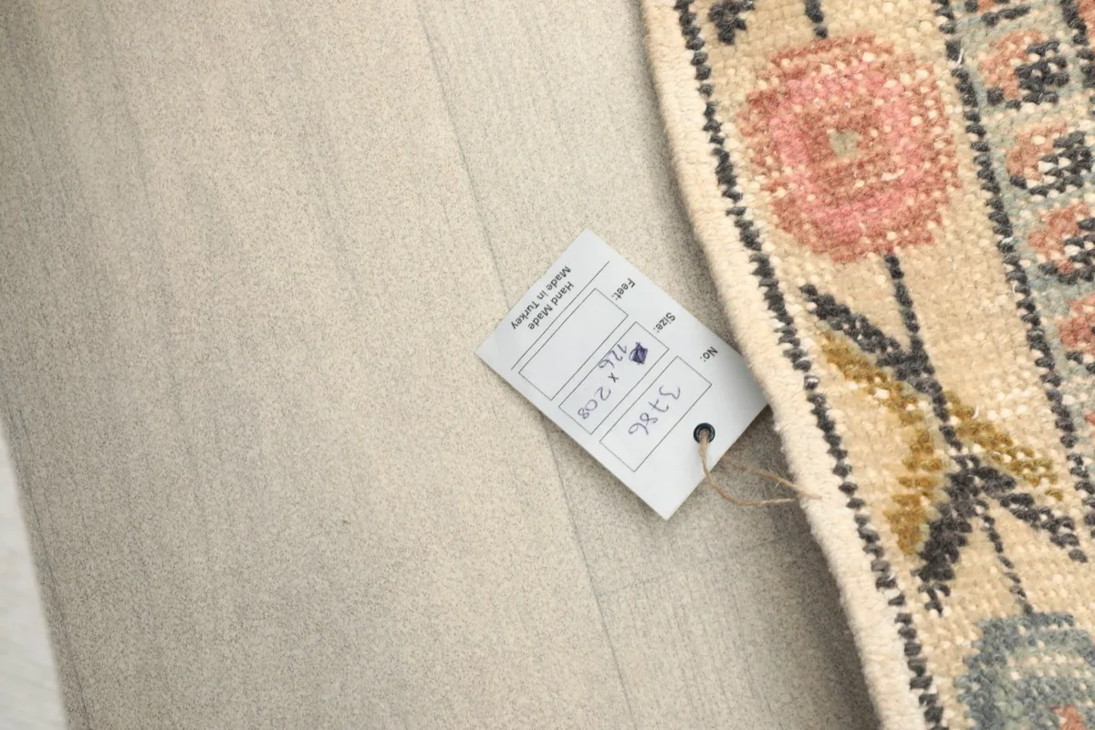 Rug tag displaying size and origin information, placed on the rug's surface