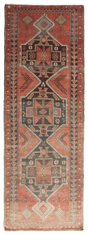 Full top view of the rust and charcoal tribal runner rug on a white background
