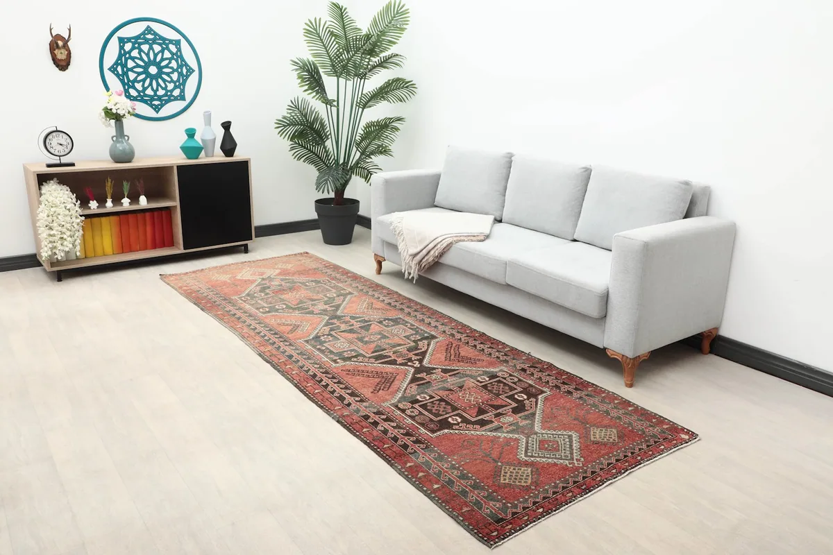 Long view of the vintage runner rug in a modern living space with a gray couch