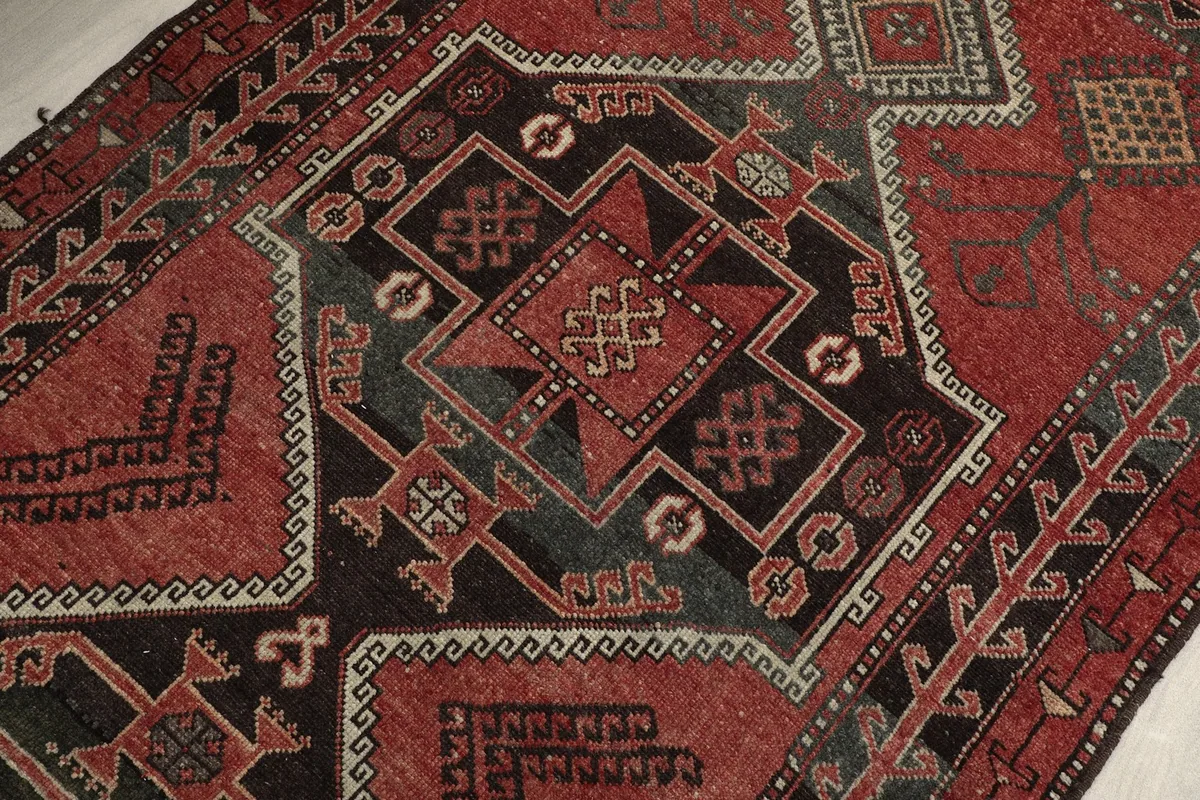 Detailed view of the central charcoal medallion and surrounding tribal motifs