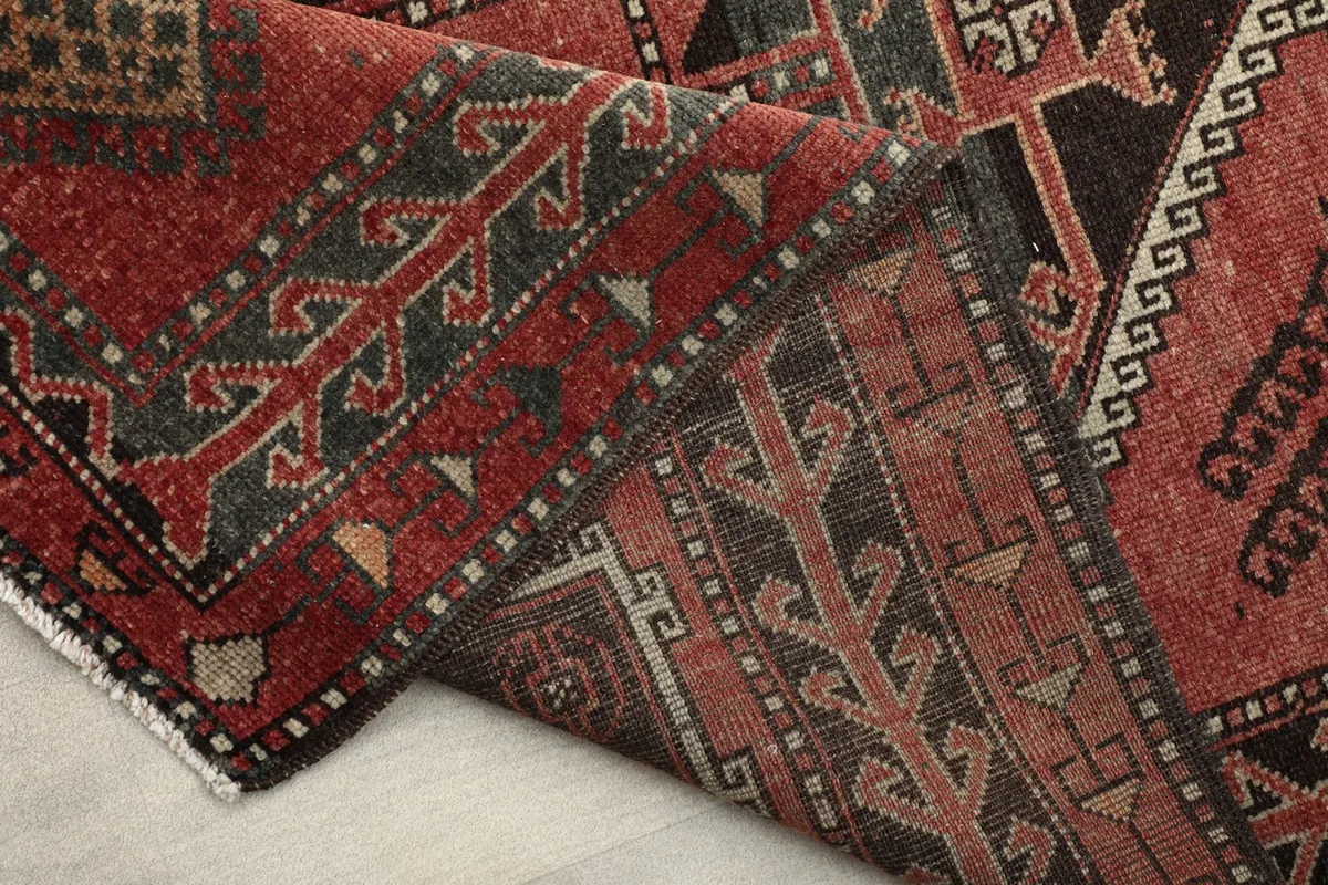 Folded section of the runner highlighting the back and front of the rug