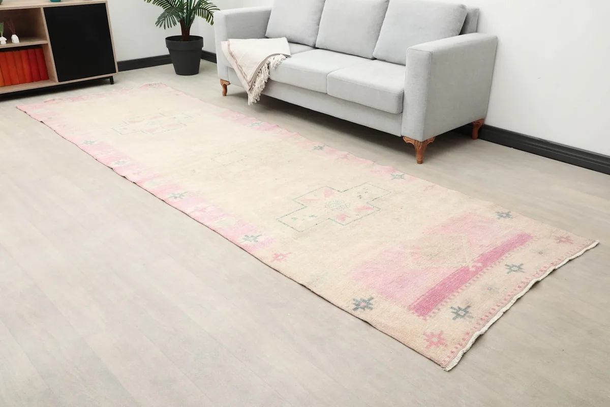 Angled view of the runner rug in a room, highlighting its geometric design and field color