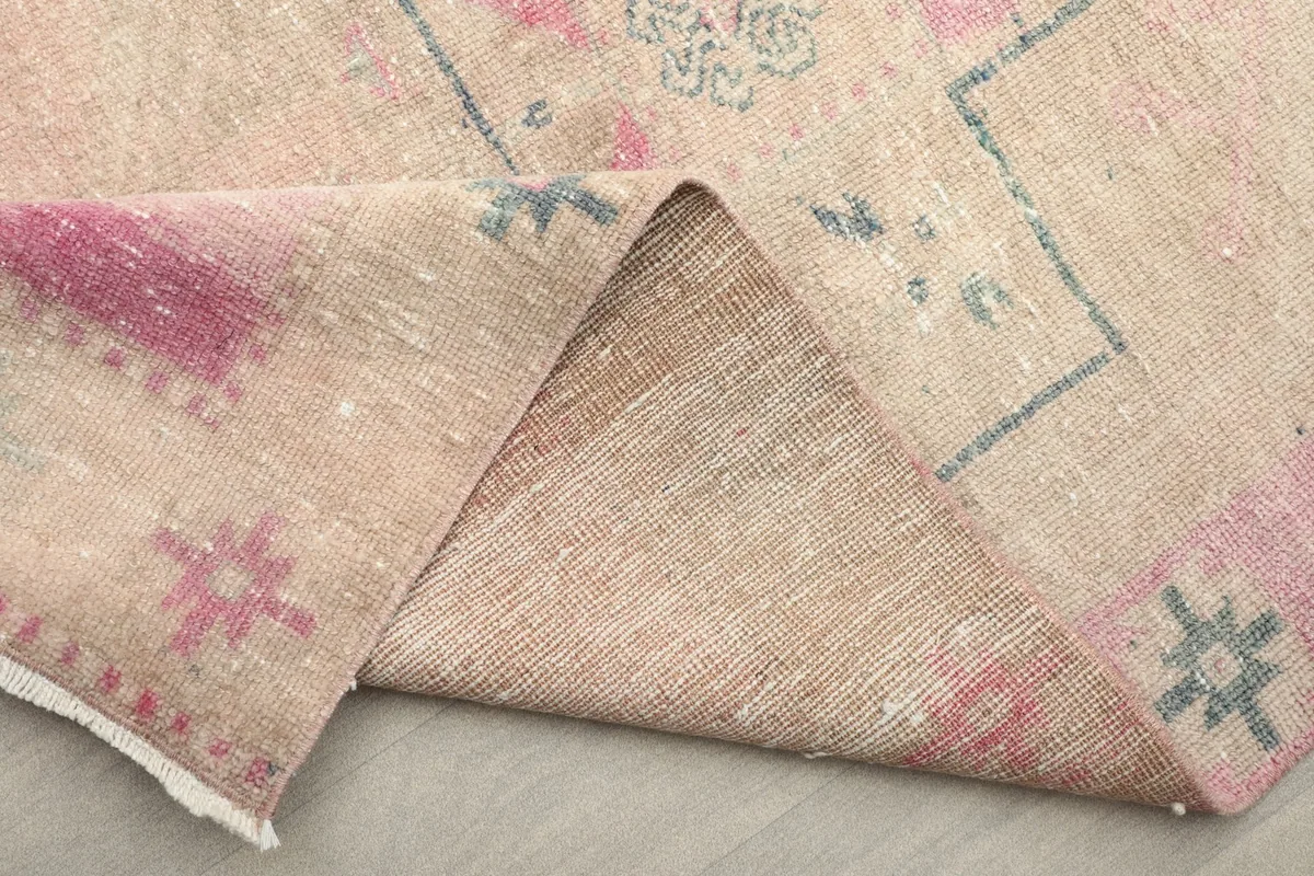 Folded corner of the runner revealing the wool pile and cotton foundation construction
