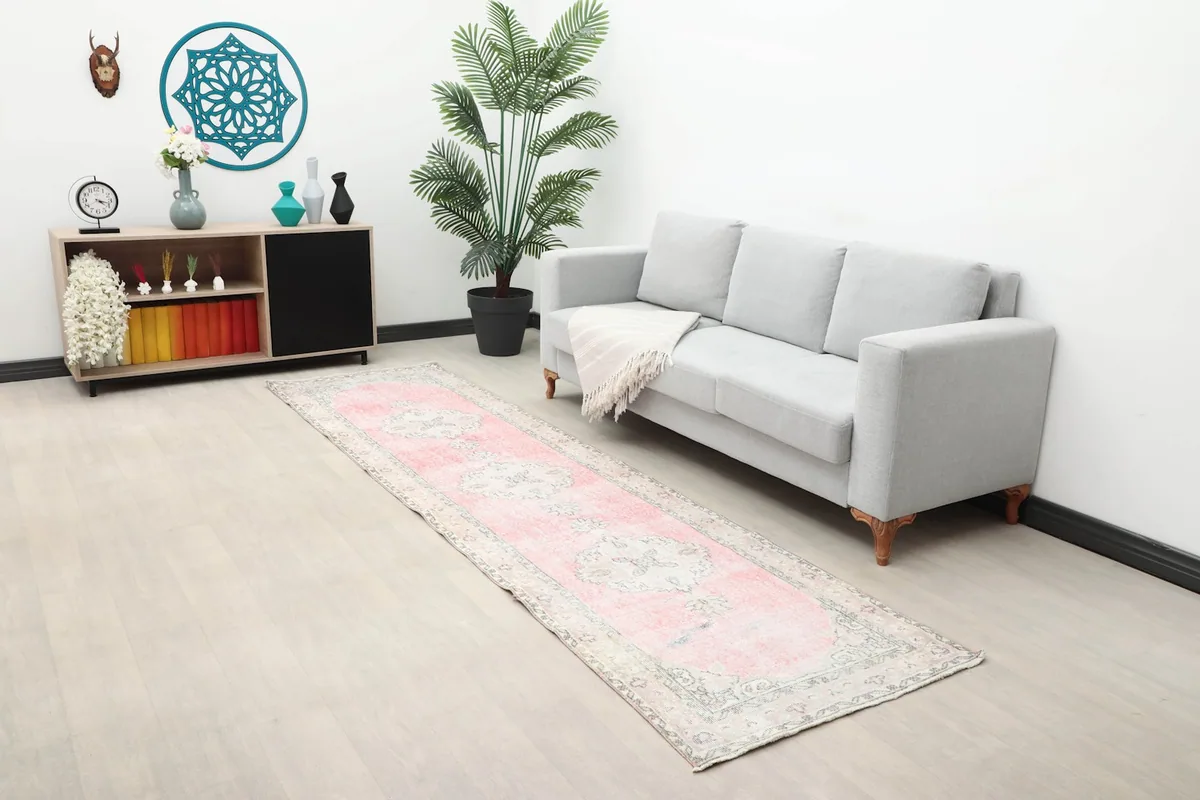 Long view of the pink runner rug in a room, showing its length in relation to furniture