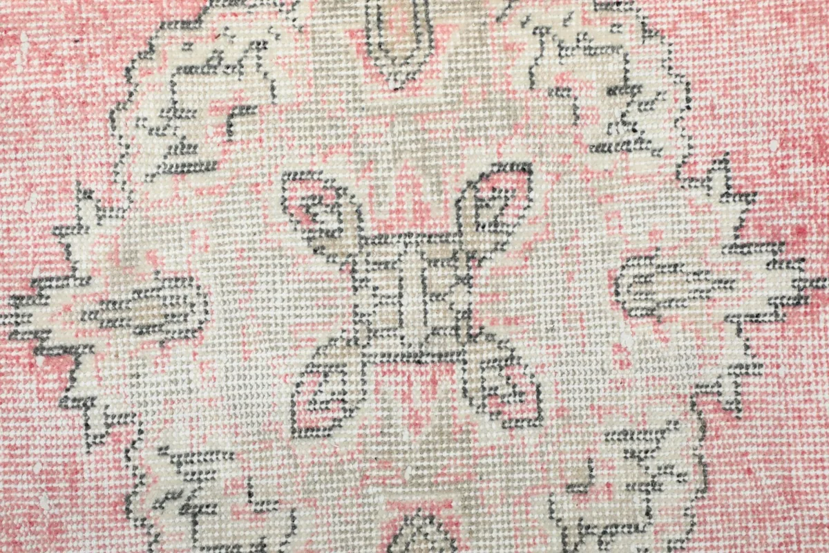 Close-up of the hand-knotted wool pile and intricate detail within a medallion
