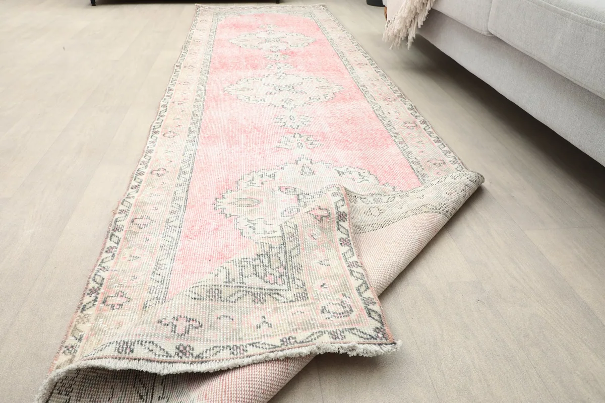 Runner rug partially folded, showing its flexibility and full length in a room setting