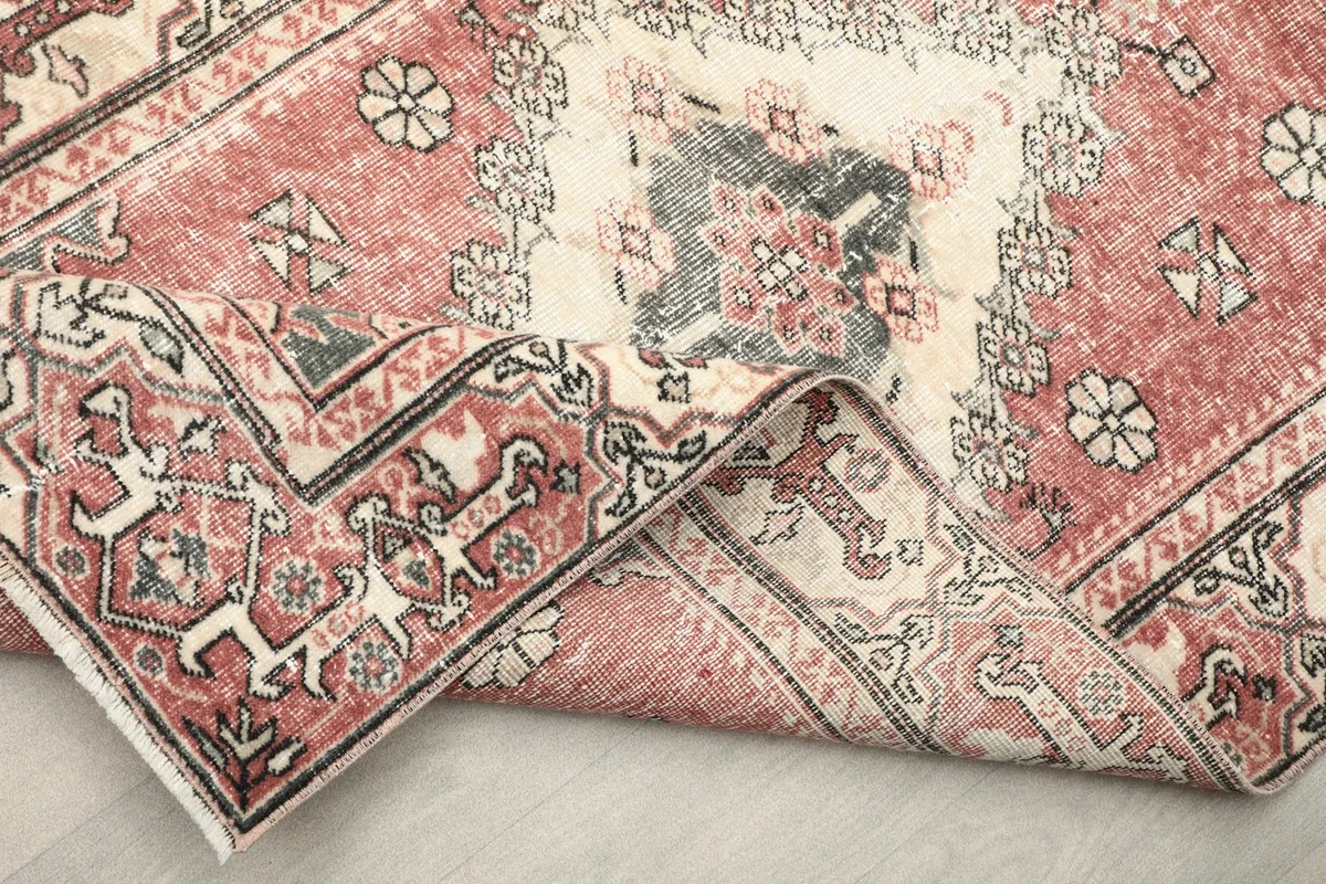 Close-up of the low wool pile and the texture of the hand-knotted vintage rug.