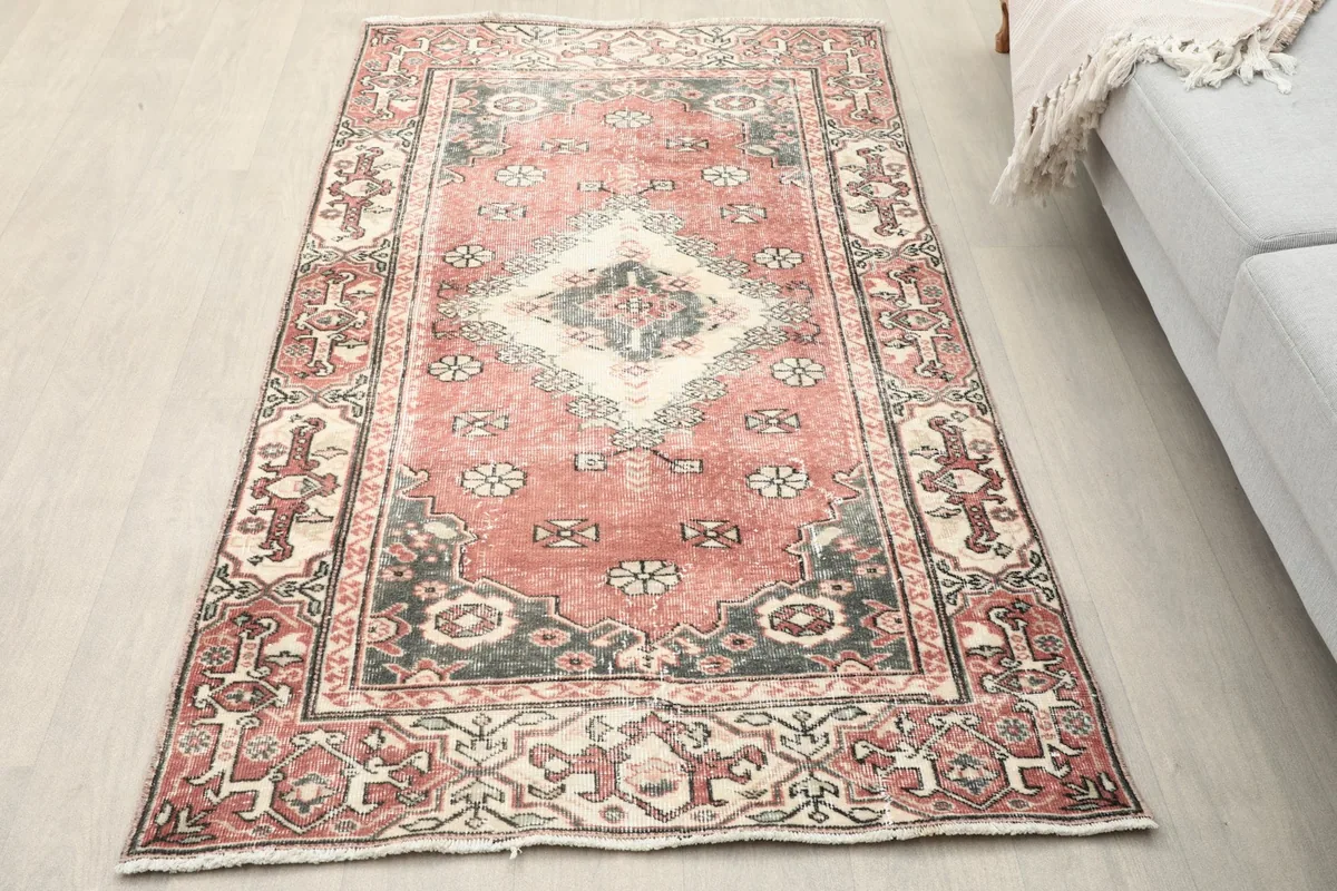 Overhead view of the vintage Anatolian rug showcasing its rose field and central medallion in a living space.