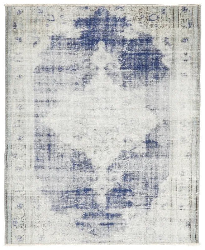 Full overhead view of the blue and cream vintage Anatolian rug on a white background