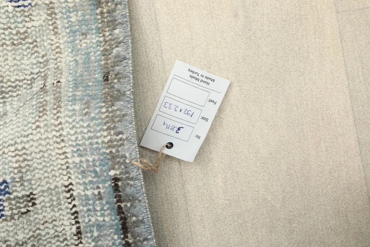 View of the rug's reverse side with the product tag showing size and origin details